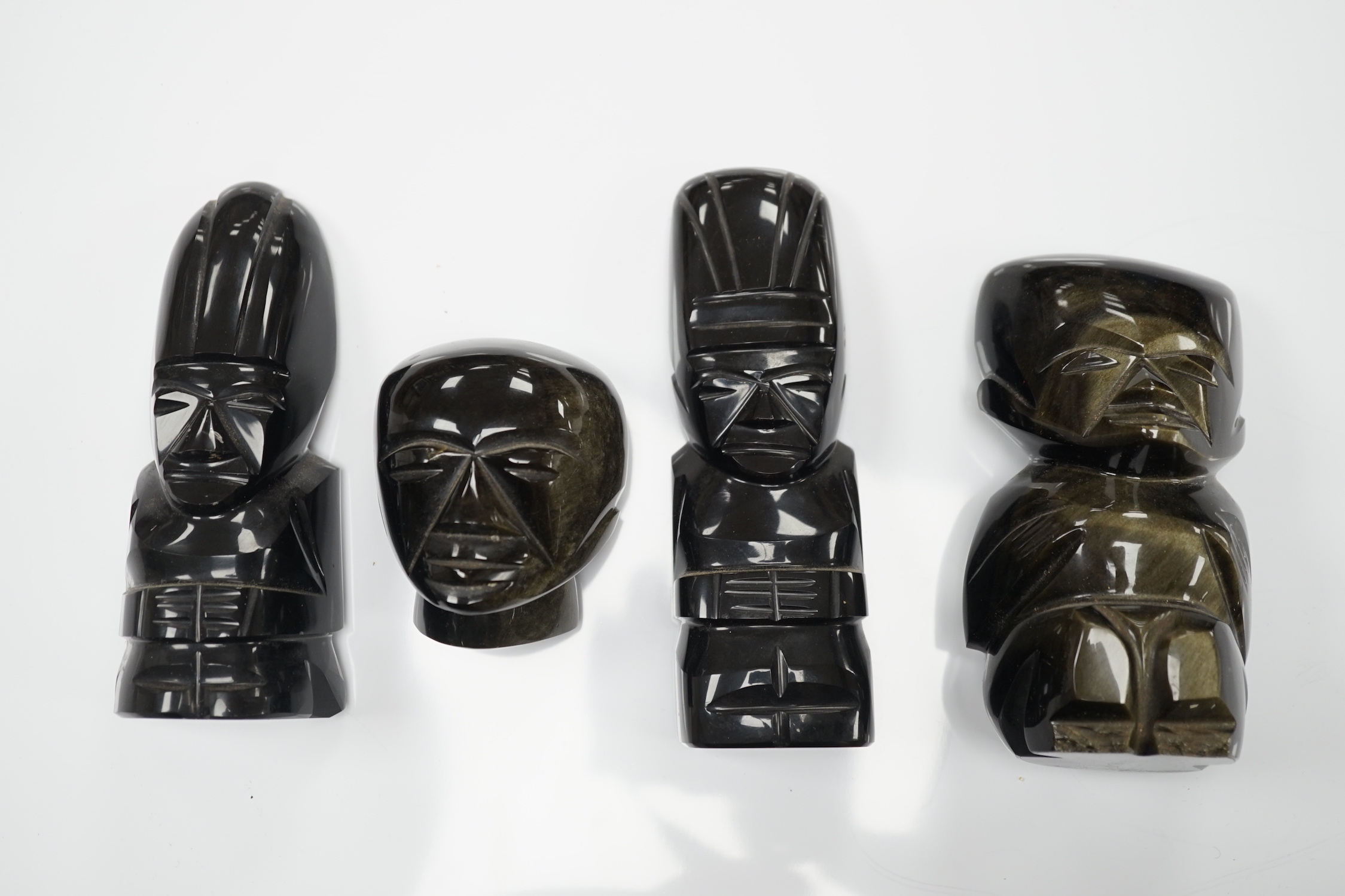 Three 20th century Aztec Mayan style carved obsidian stylised figures and a similar mask (4) tallest 15cm